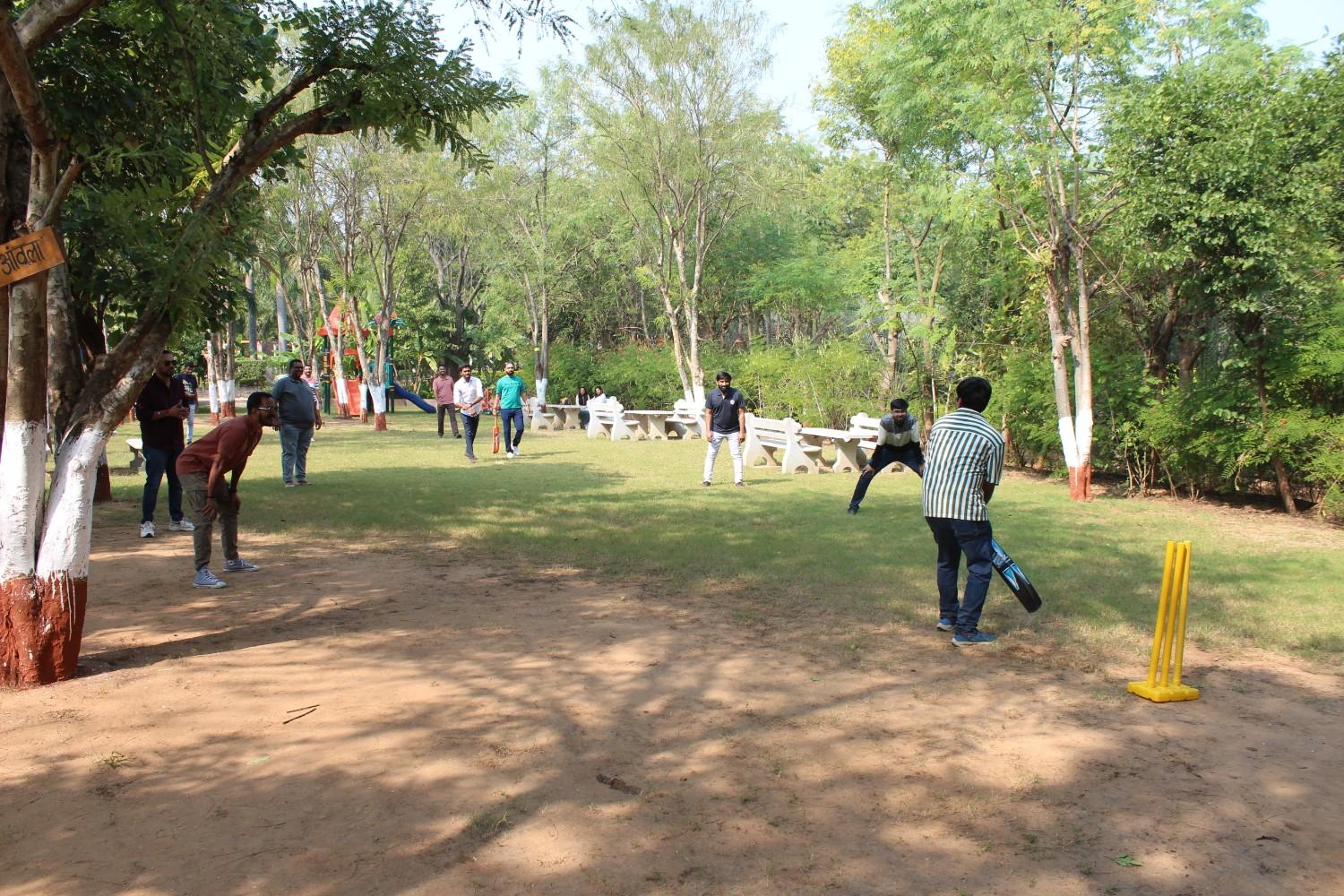 Family playing outdoor cricket