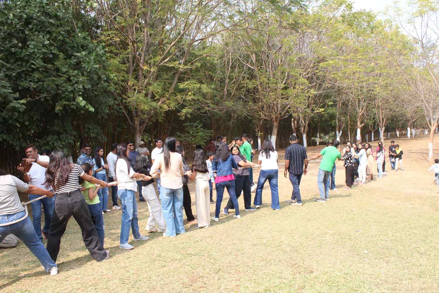 Wide shot of corporate group playing fun outdoor team games