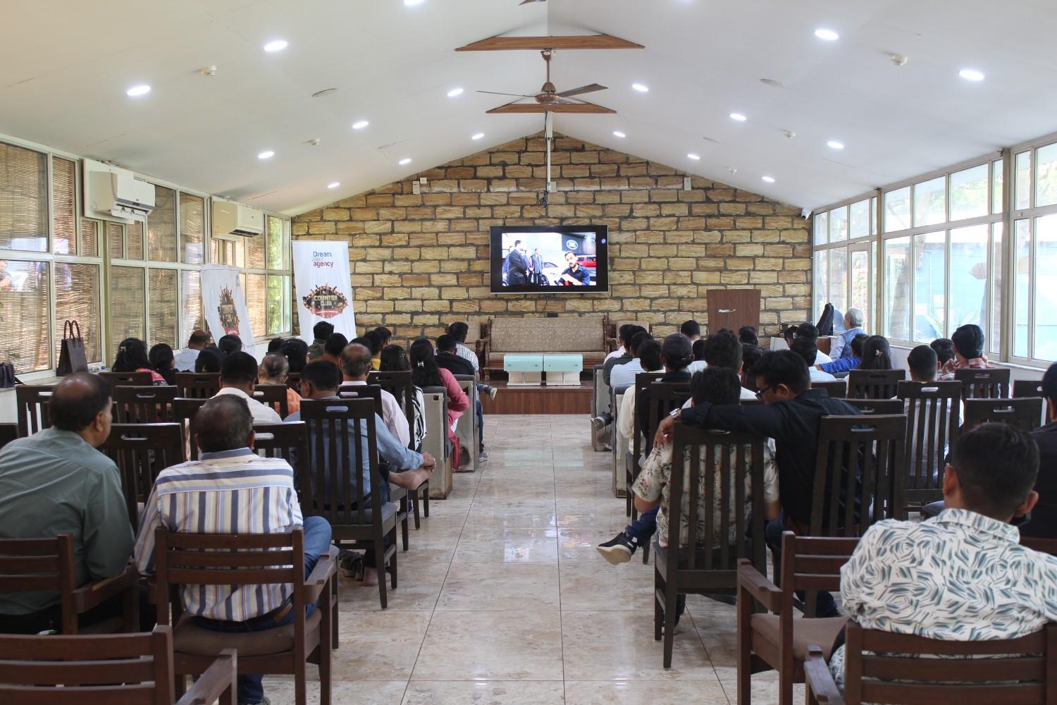 Team watching corporate presentation in hall