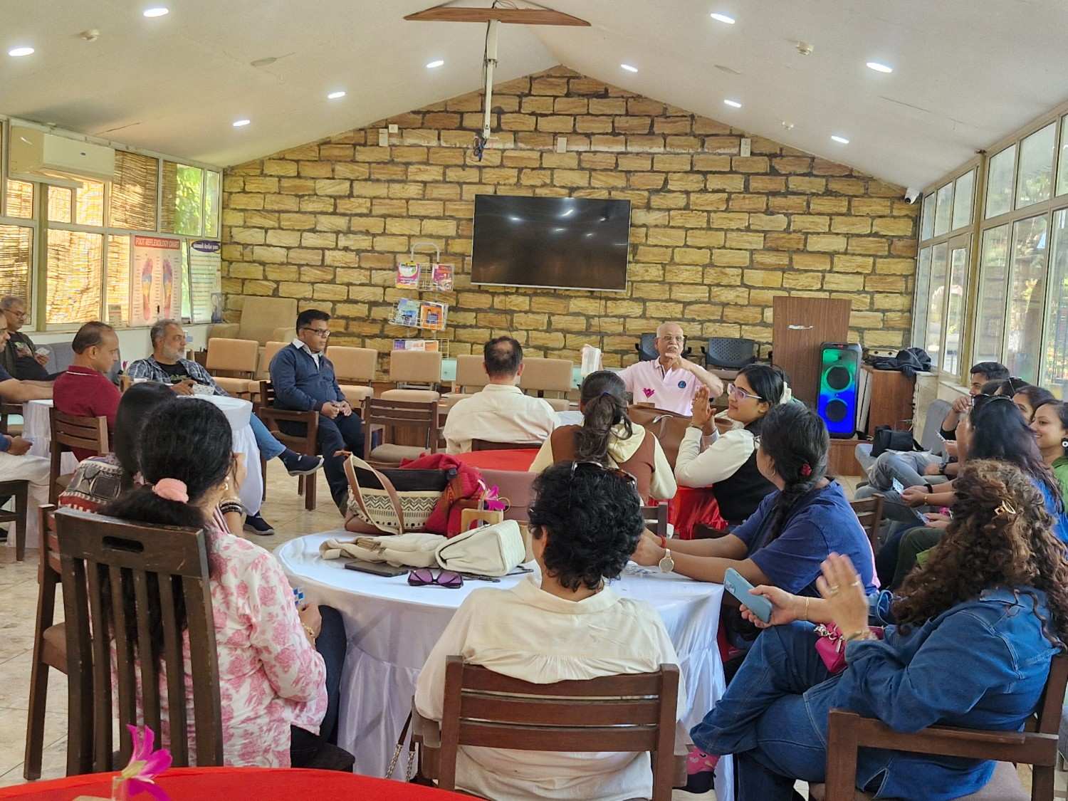 Team sitting in workshop hall