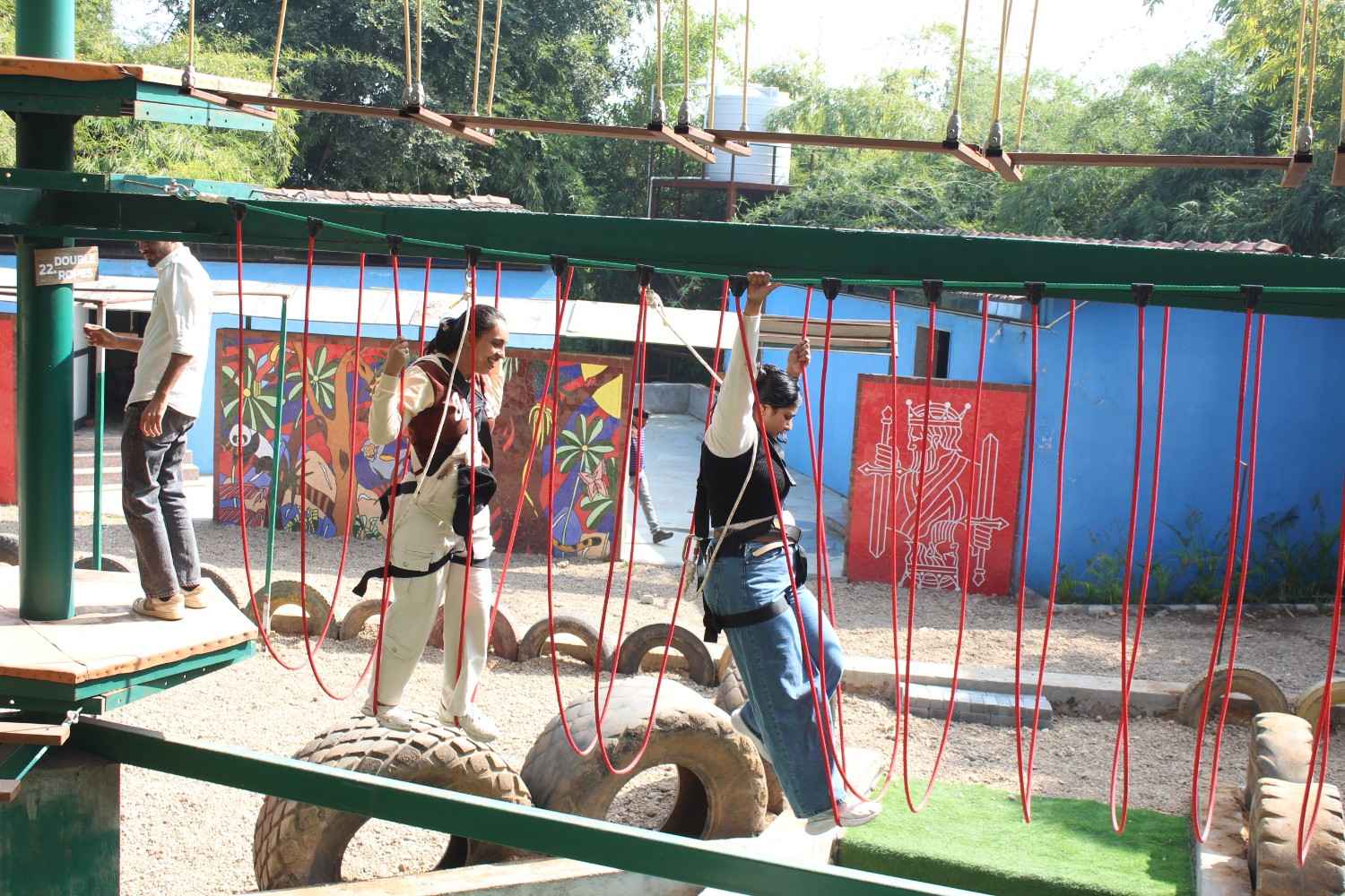 Women crossing the tire bridge